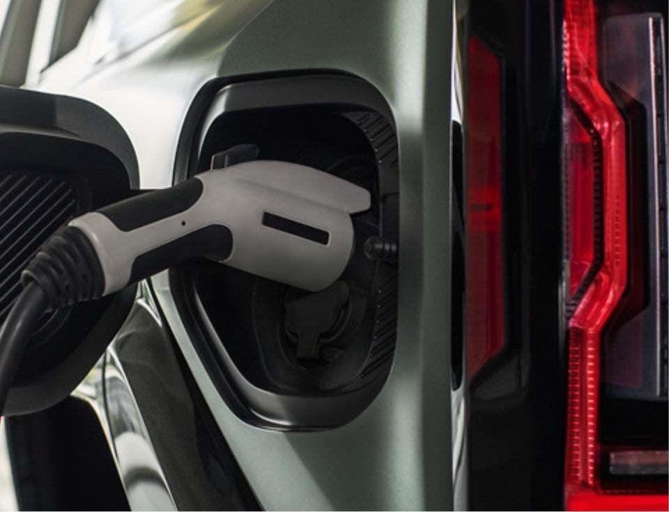Close up of charging port with charger plugged in on a GMC Hummer EV SUV - Bergstrom GMC of Manitowoc in MANITOWOC WI