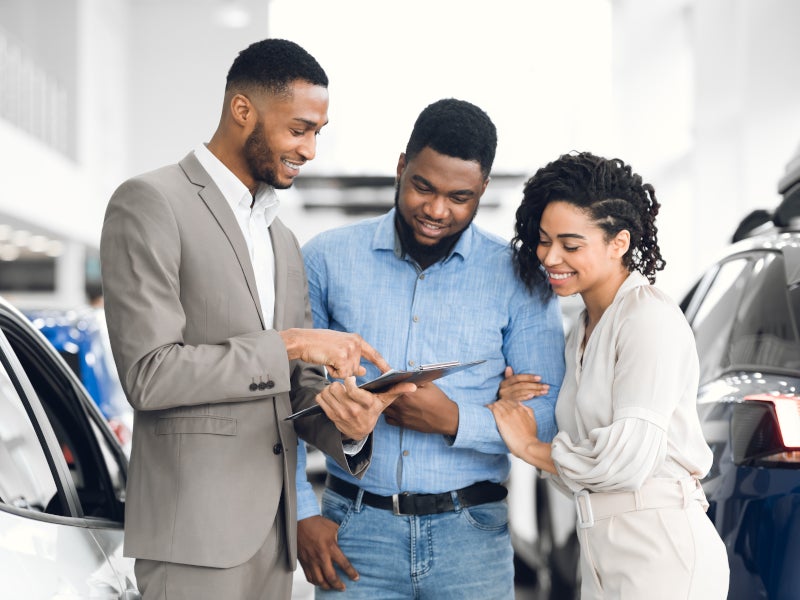 Couple looking through vehicle options in Manitowoc, WI GMC dealership